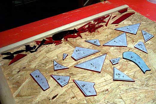 14 new red pieces, plus the new blue problem child. Very little scrap. I even shared some edge cuts between two pieces. Yeah, I know I said you can't really do that. I meant, except if you're cutting a whole bunch of like-sized equilateral triangles. Or rectangles.